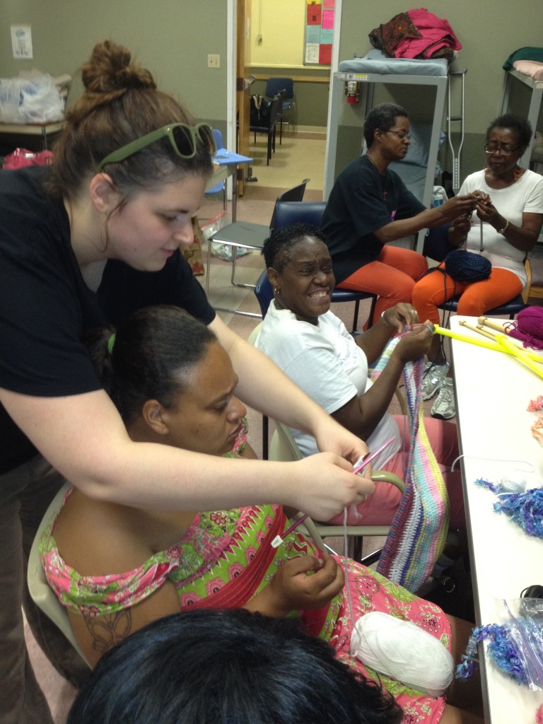 Jackie demonstrating how to knit